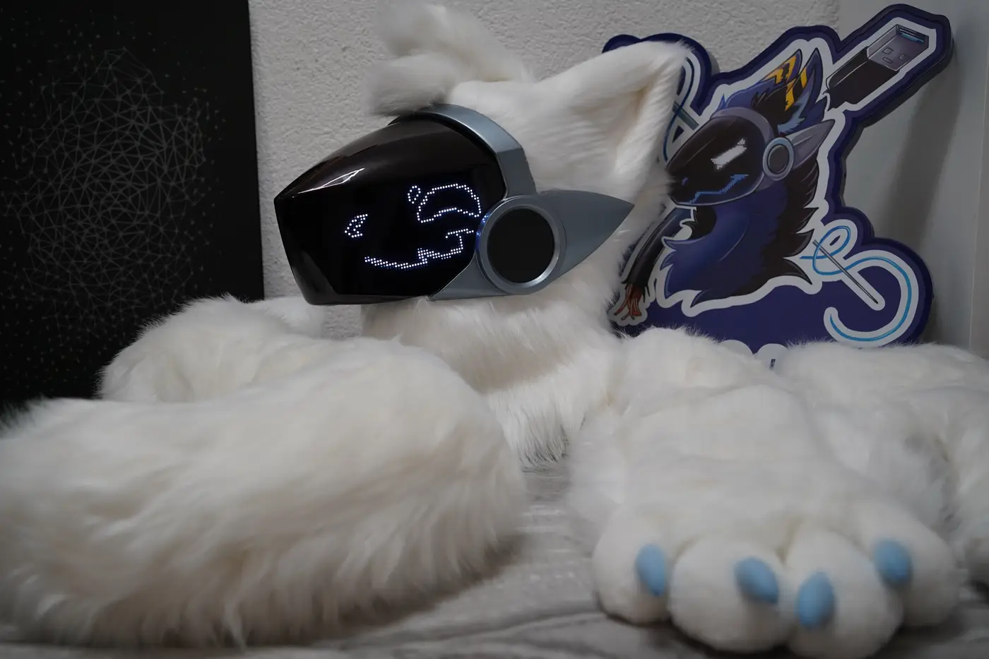 White Protogen half partial with the head, a large canine shaped tail and puffy hand paws with light blue claws
