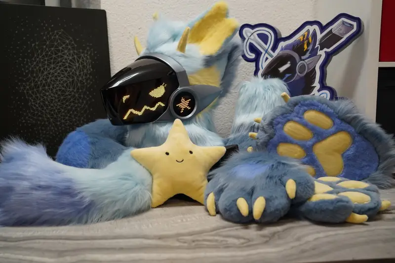 Light blue Protogen partial with the head, tail, paws and a smiling yellow star plush