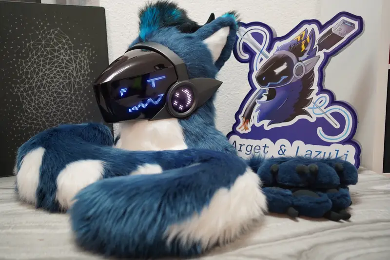 Teal and white Protogen head, hand paws and tail with the Arget and Lazuli logo