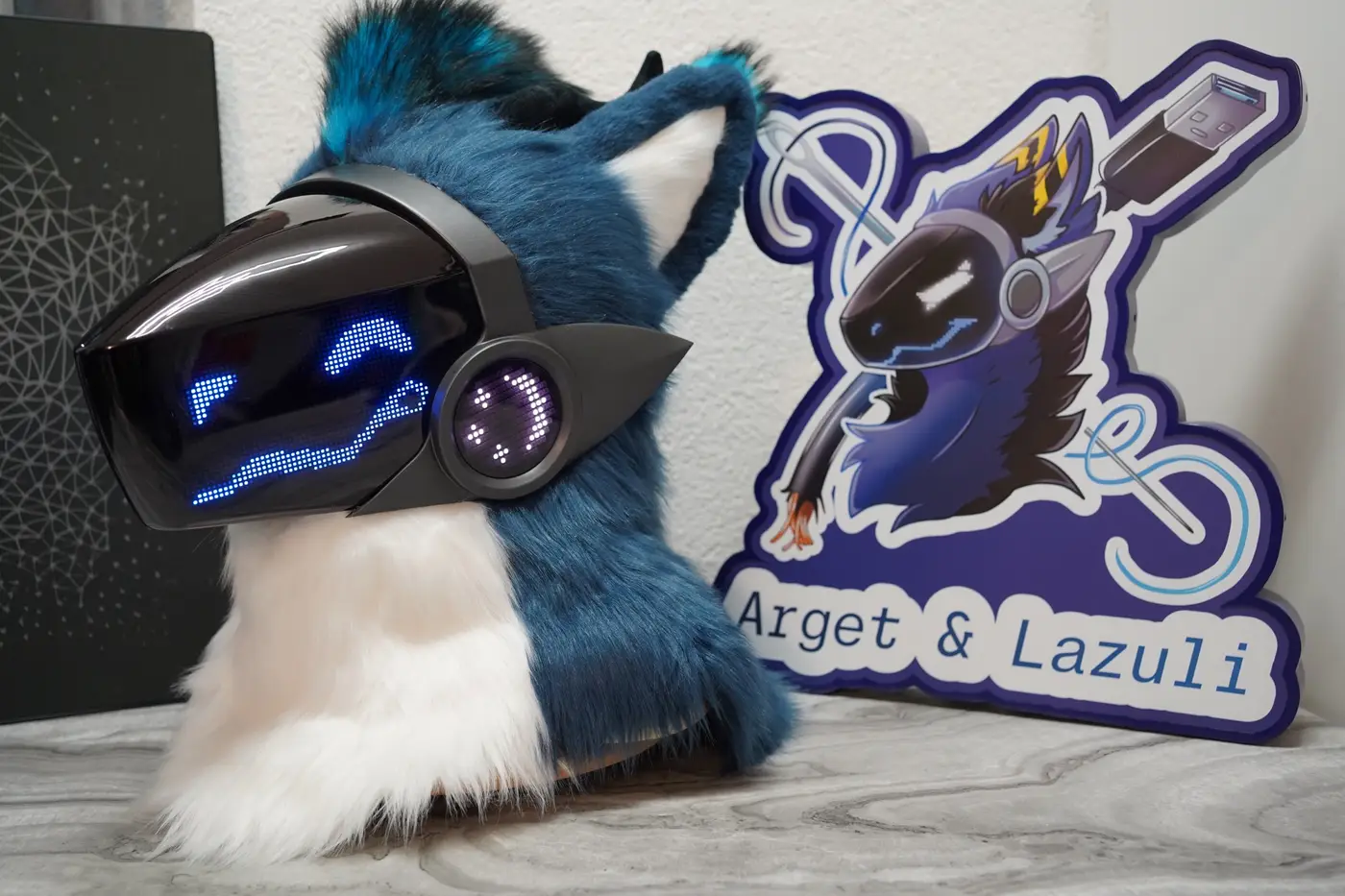 Teal and white Protogen head with a blue smile on the black LED visor