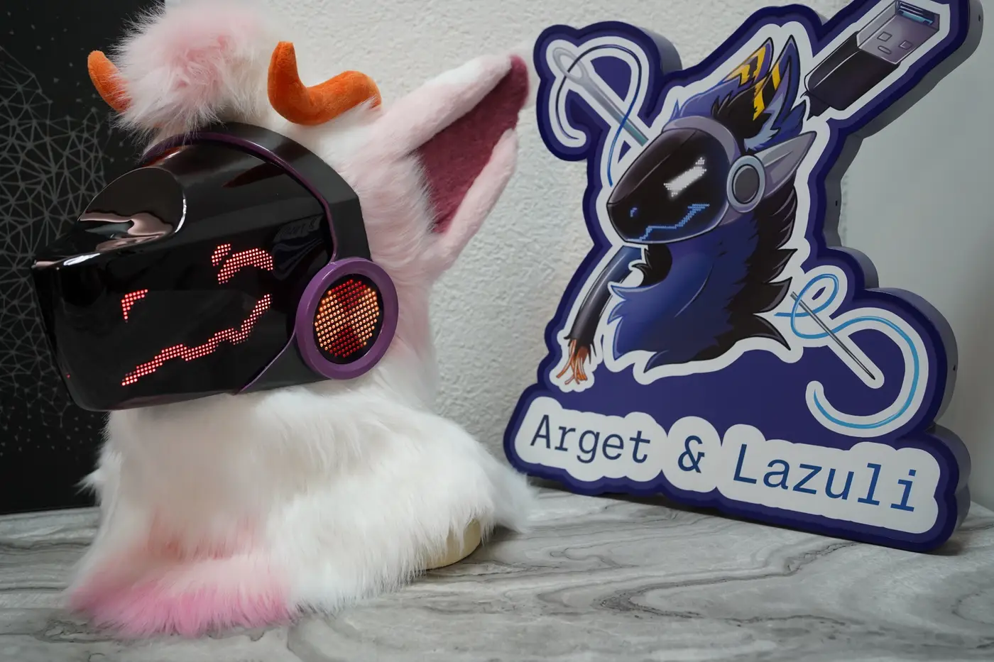 White and pink Protogen head with orange horns and a red face on the black LED visor