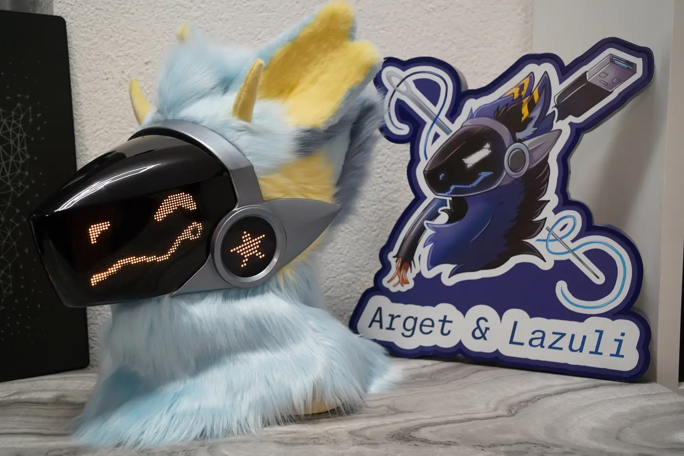 Light blue Protogen head with a yellow winking pixel eye and a star on the cheek disc