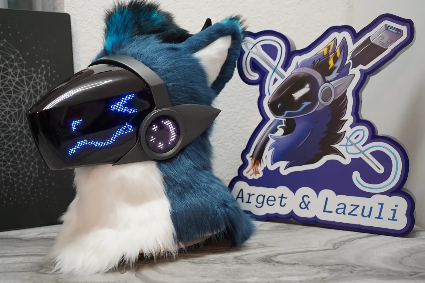 Teal and white Protogen head with one blue eye squinted on the LED visor
