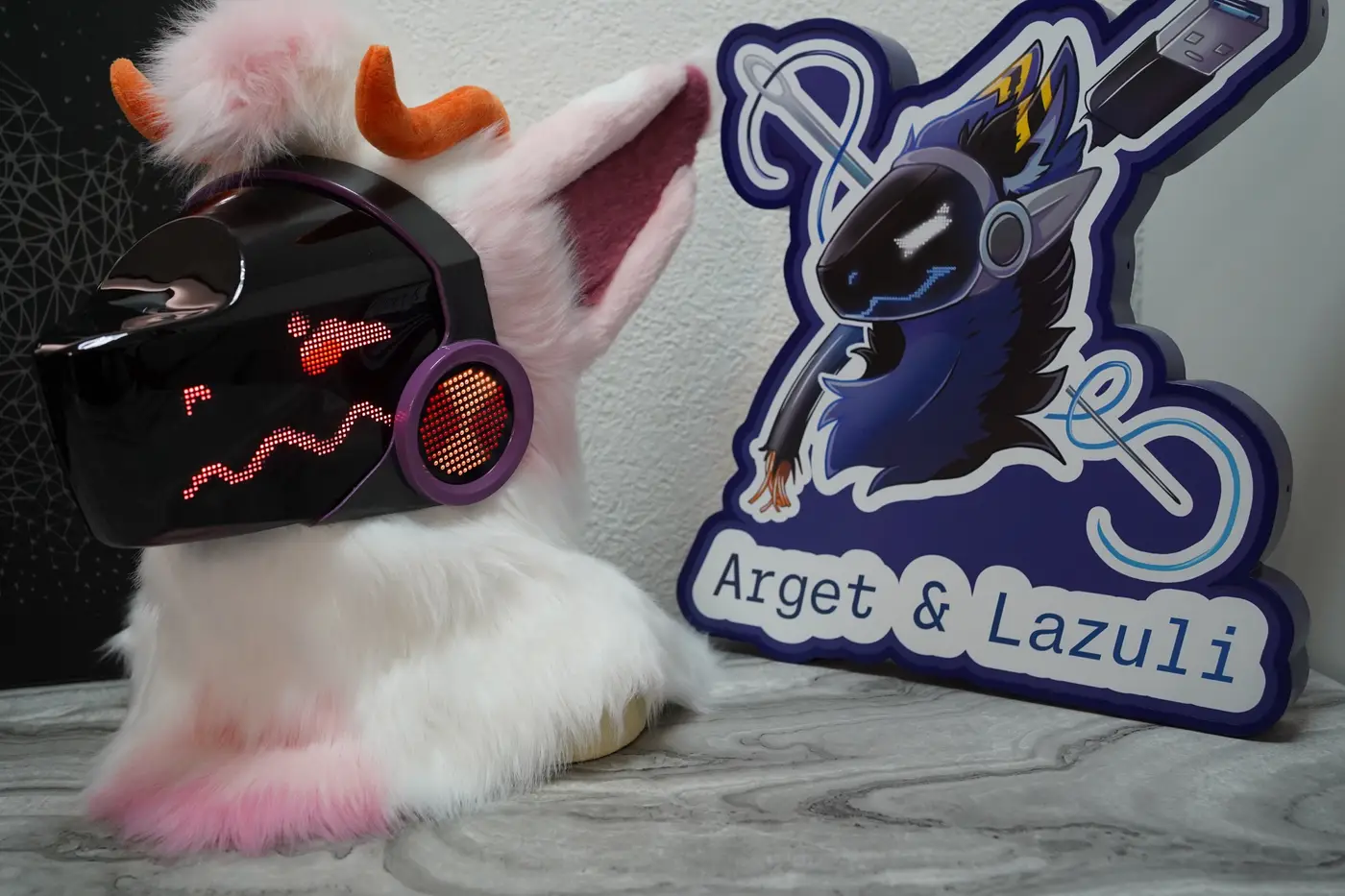 White and pink Protogen head with small red eyes and a wavy mouth on the LED visor