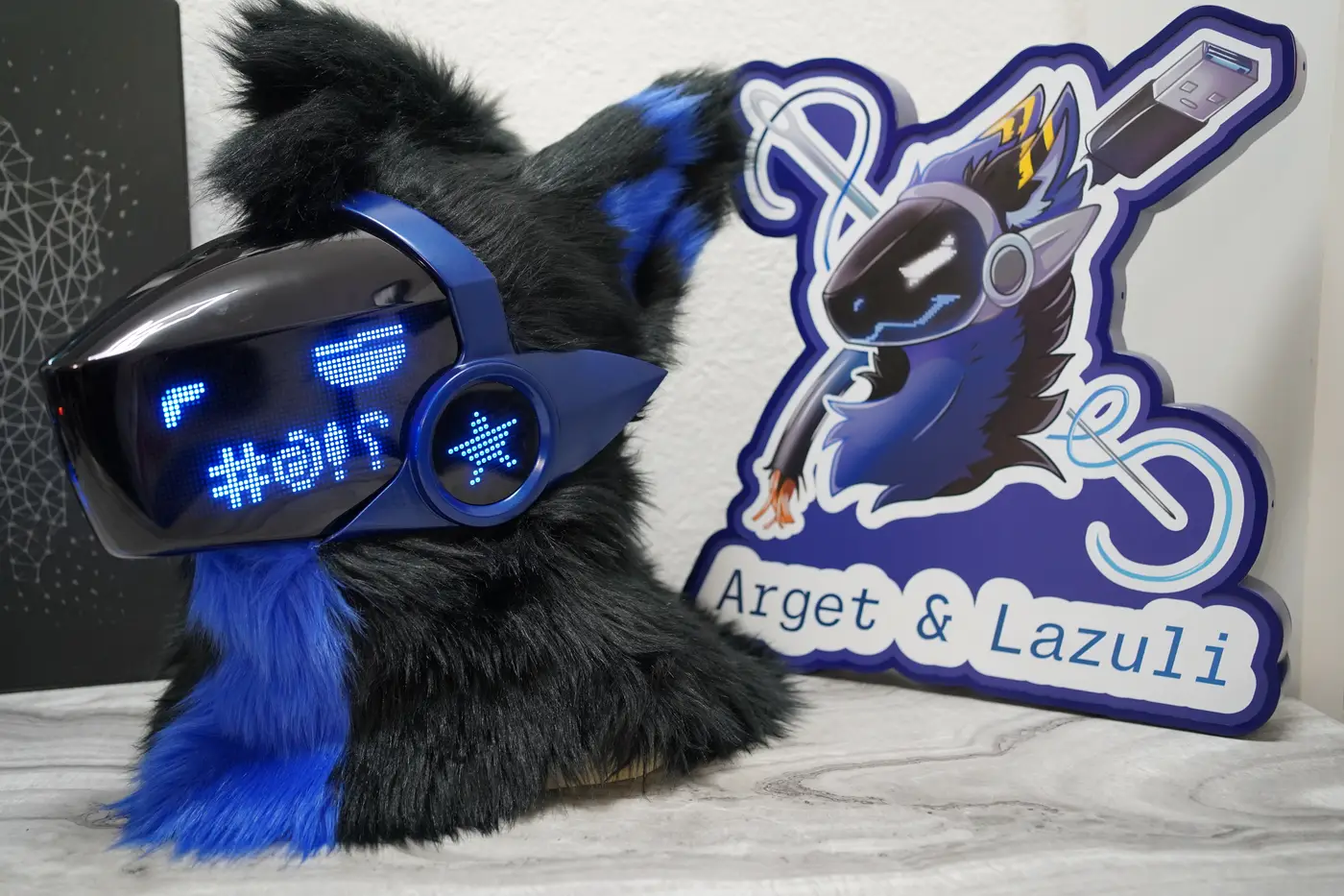 Black Protogen head with blue symbols across the LED visor