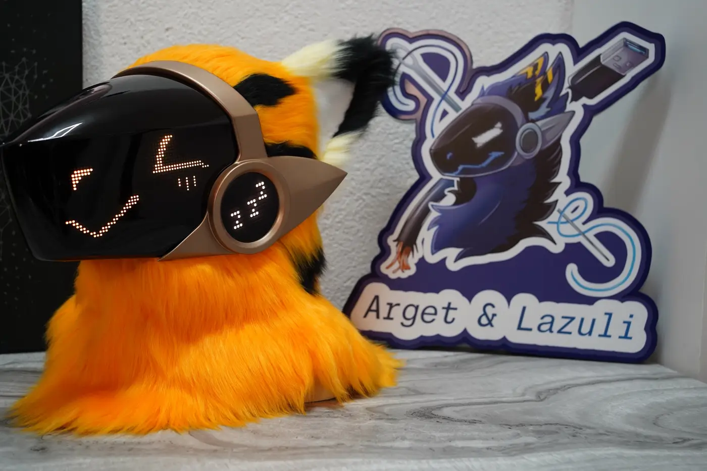 Orange Protogen head with narrow orange eyes and a flat mouth on the LED visor