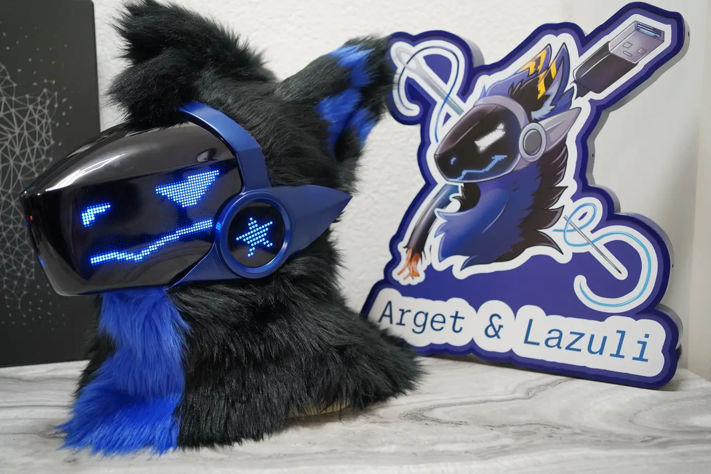 Black Protogen head with a blue triangle eye and a wavy mouth on the LED visor