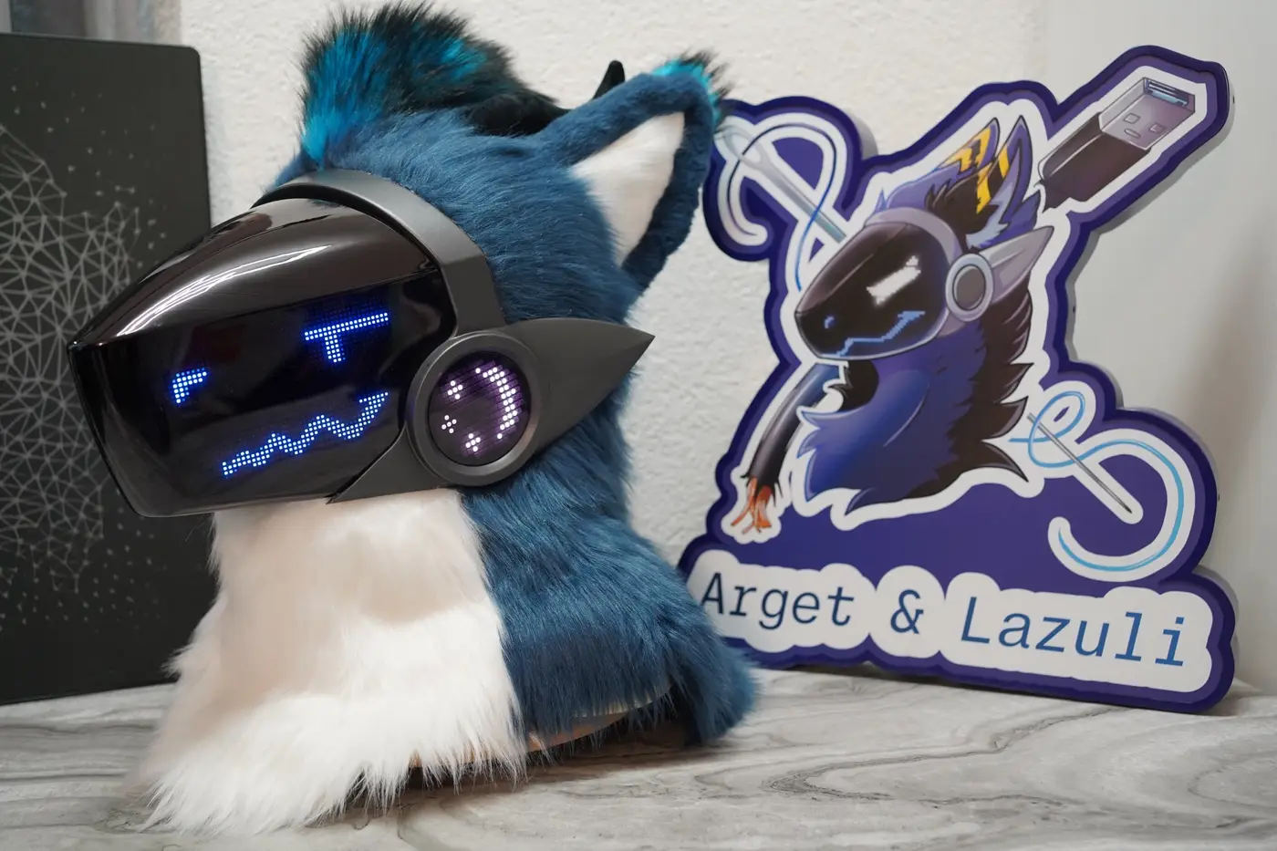 Teal Protogen head with small blue eyes and a curved mouth on the LED visor