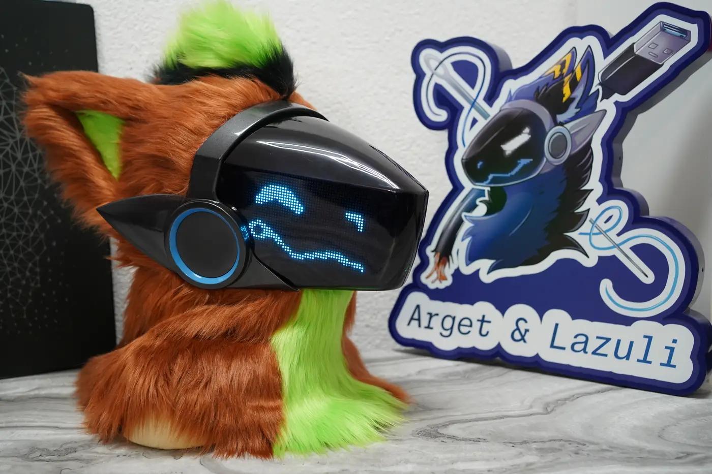 Rust brown Protogen head from the other side, with a blue pixel face and a blue ear light on the LED visor