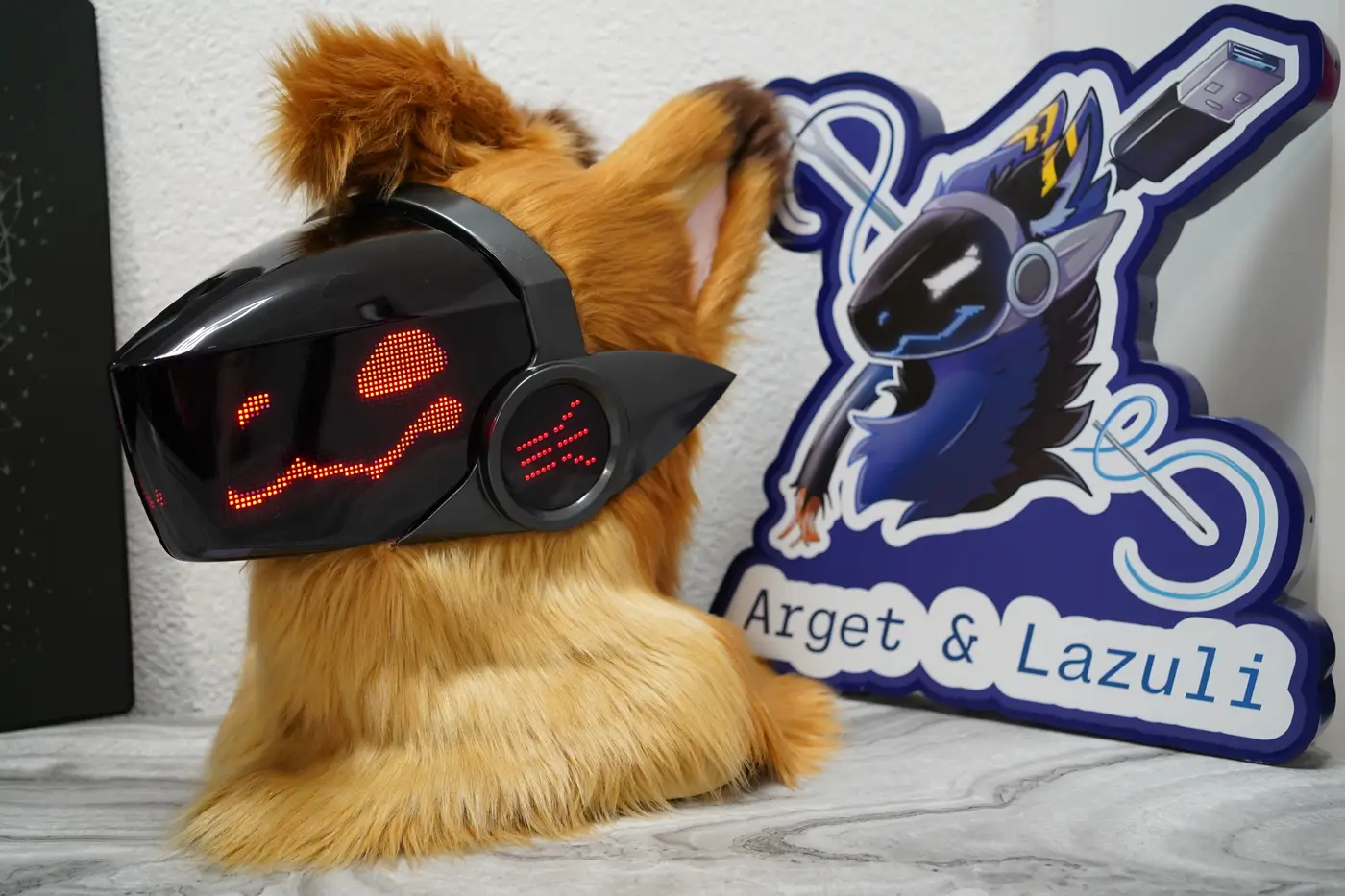 Tan Protogen head with an angry red pixel expression on the black LED visor