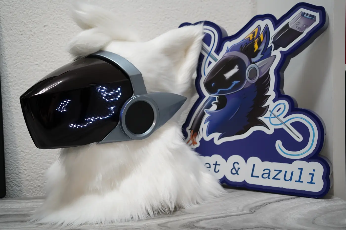 White Protogen head with squinting white pixel eyes and a small pixel smile on the black LED visor
