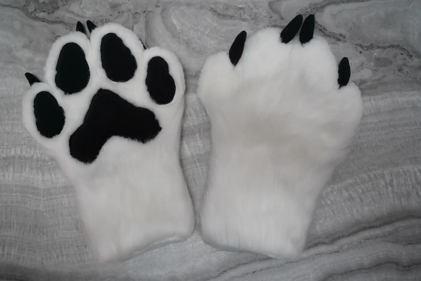 White Protogen hand paws with black pads and claws