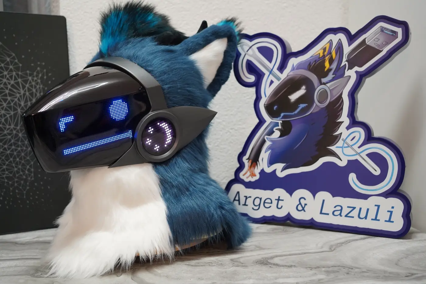 Teal and white Protogen head with straight blue eyes and a flat mouth on the LED visor