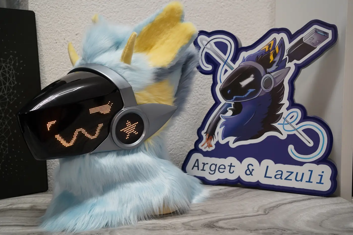 Light blue Protogen head with a yellow zigzag pixel expression on the LED visor