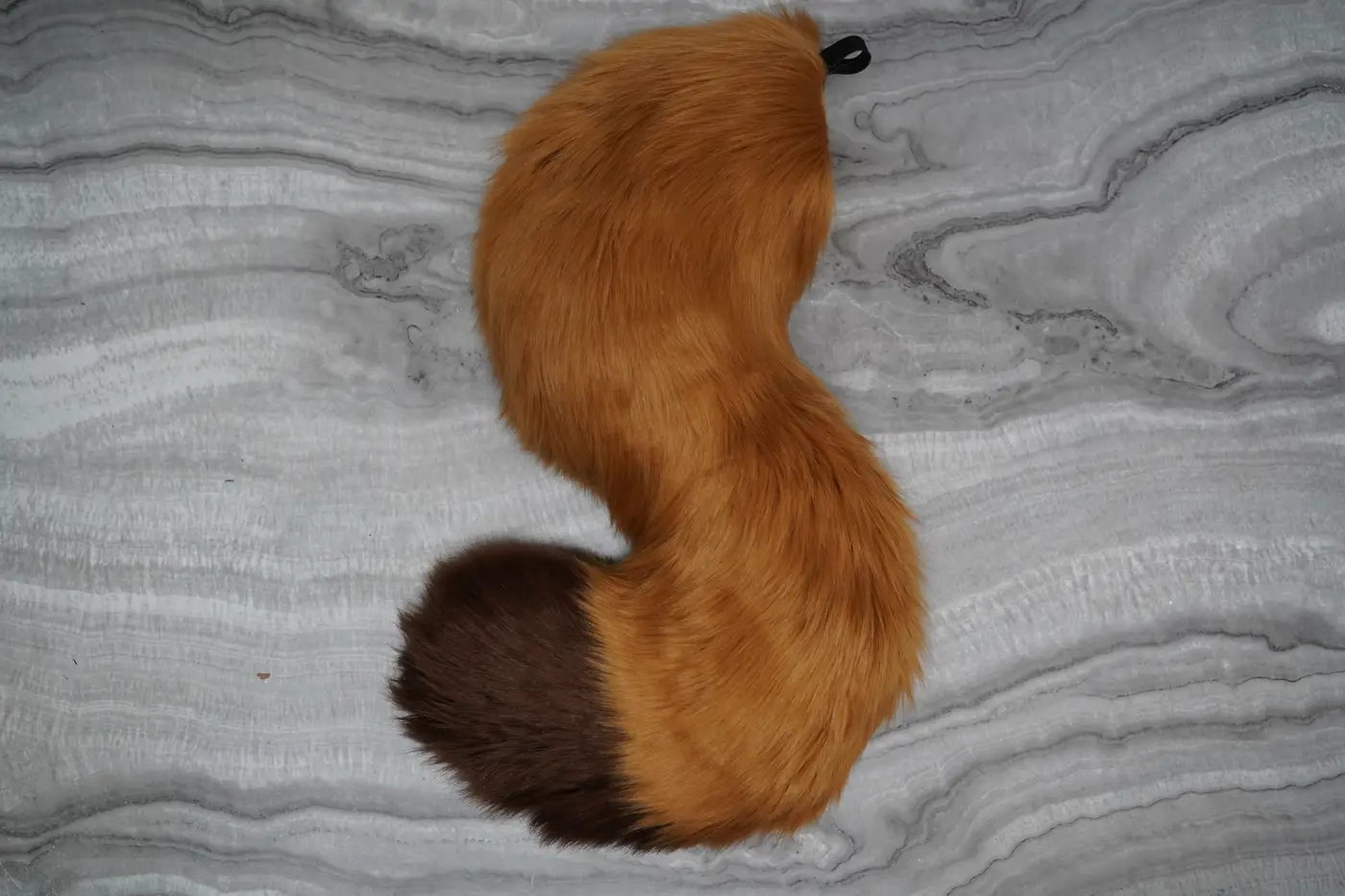 Tan fursuit tail with a dark brown tip, hand sewn for the Protogen mini partial