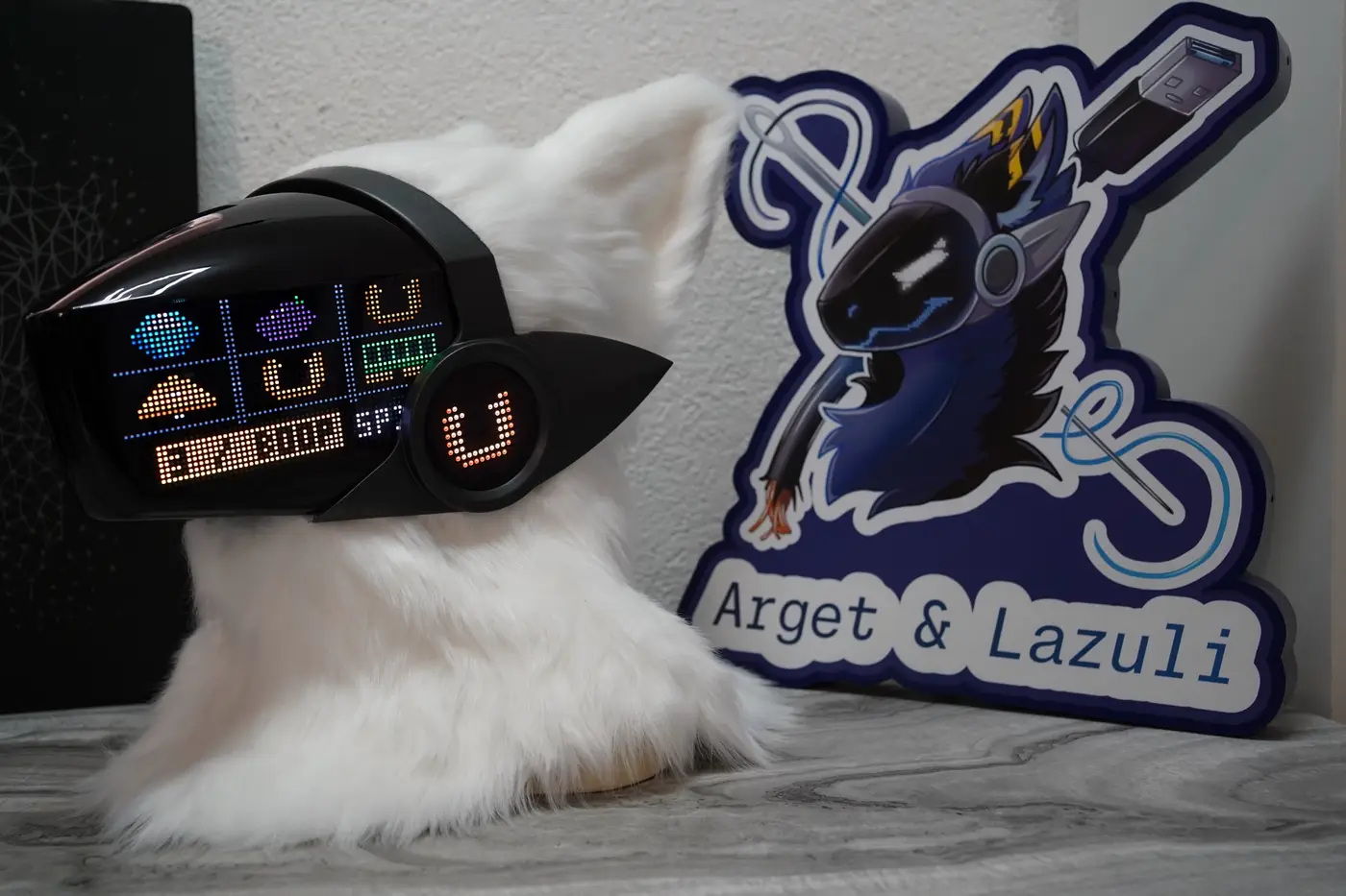 White Protogen head with colour game icons and a status bar on the LED visor