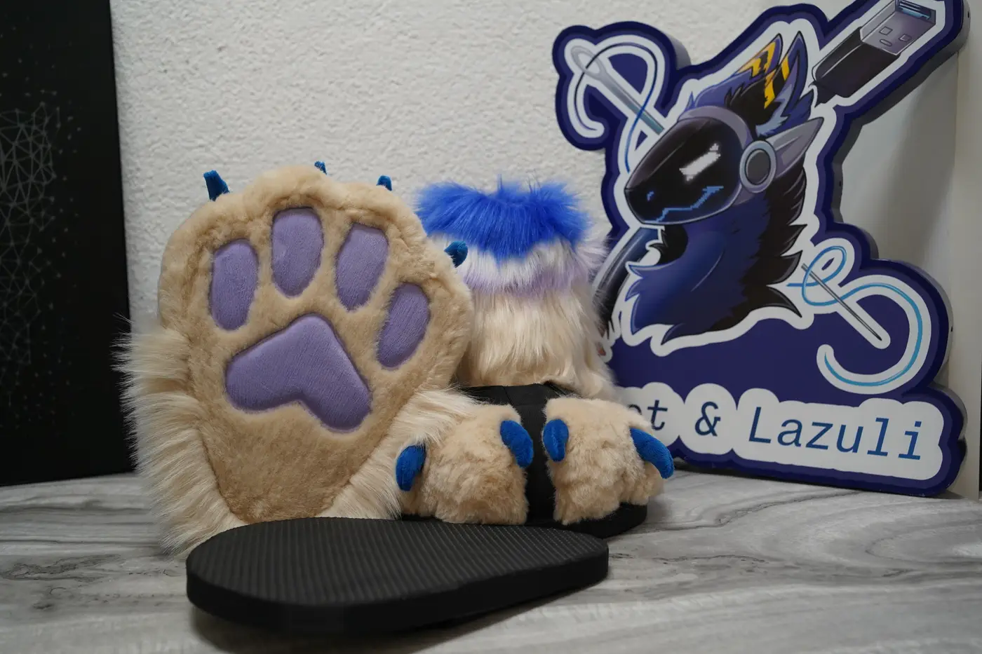 Cream Protogen feet paws with lavender paw pads and blue claws on their black outdoor sole sandals