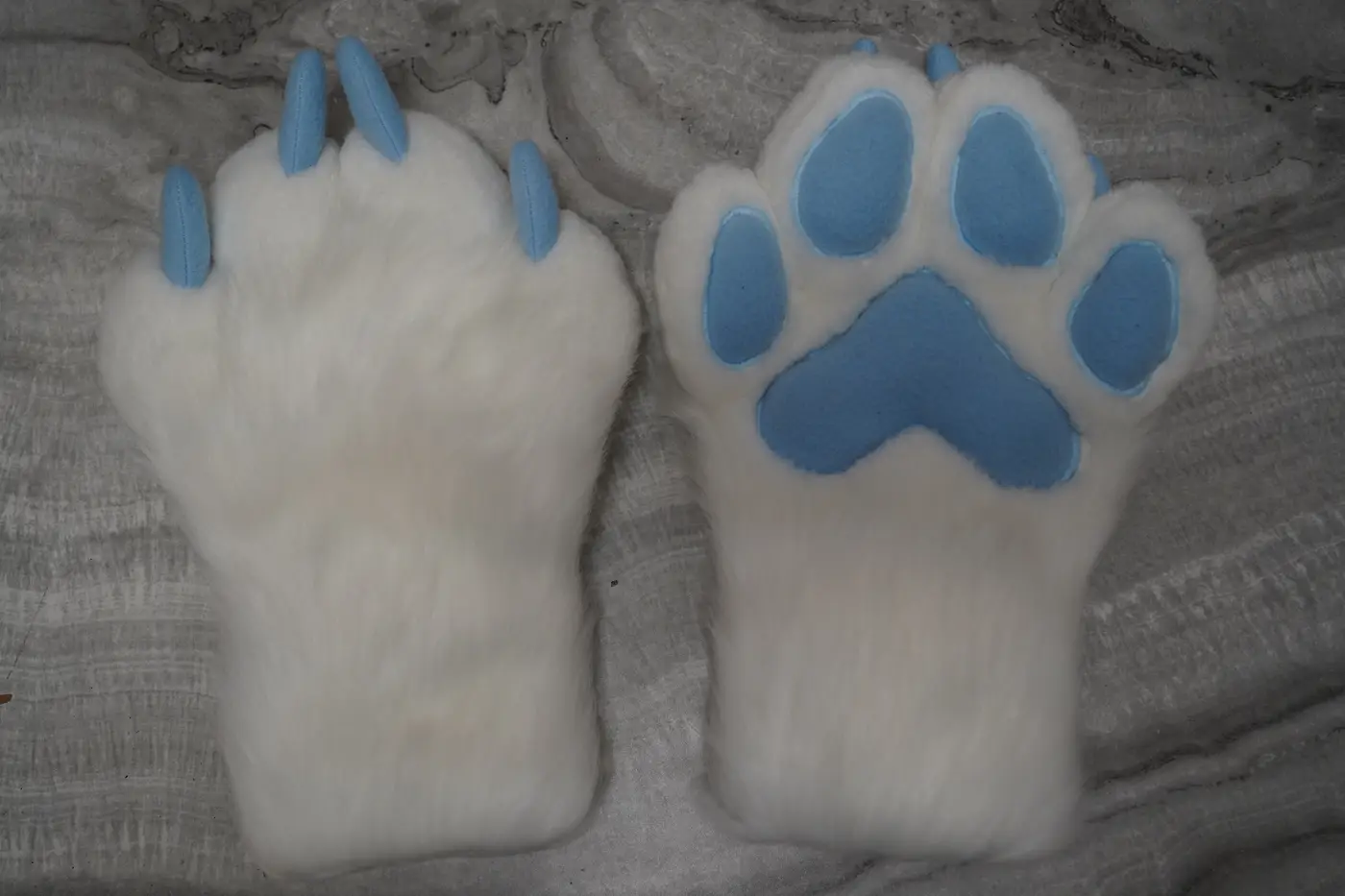 White four finger puffy Protogen hand paws with light blue paw pads and light blue claws