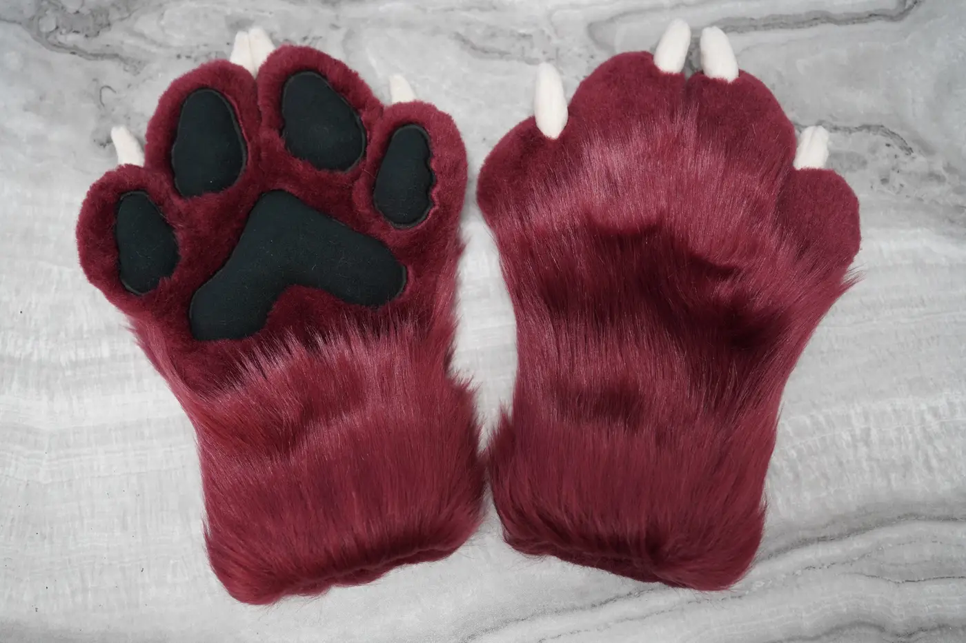 Burgundy Protogen hand paws with black pads and white claws