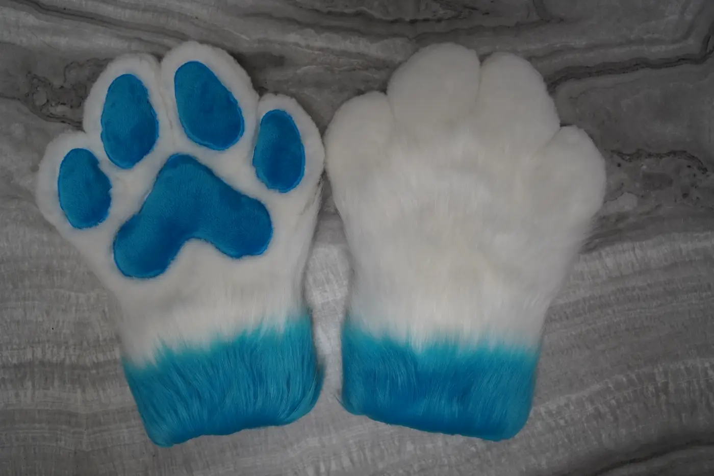 White four finger puffy Protogen hand paws with turquoise paw pads and turquoise cuffs, made without claws