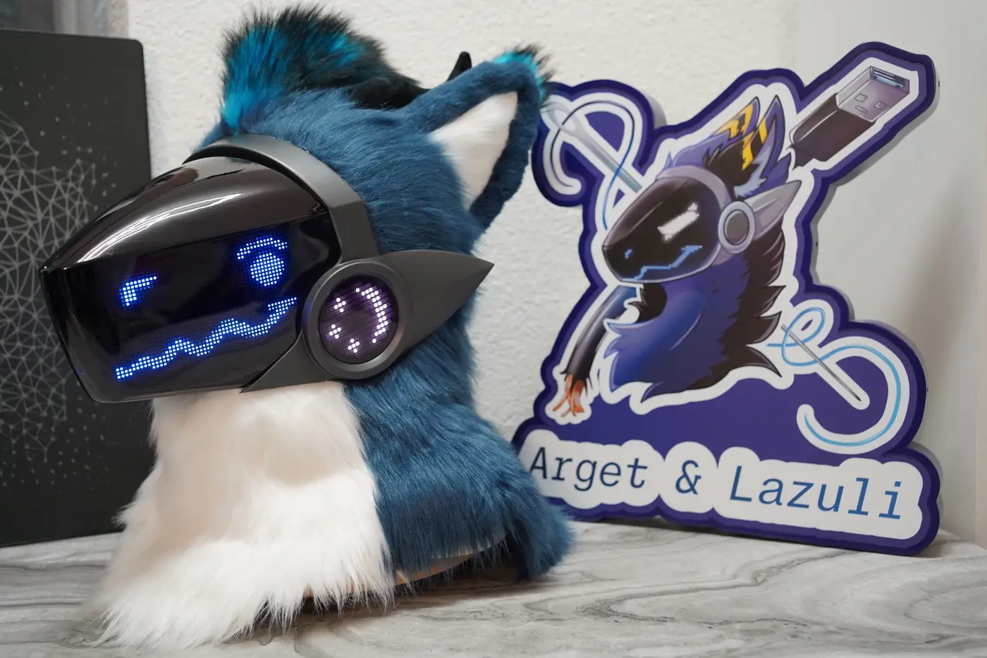 Teal Protogen head with one round blue eye and a straight mouth on the LED visor