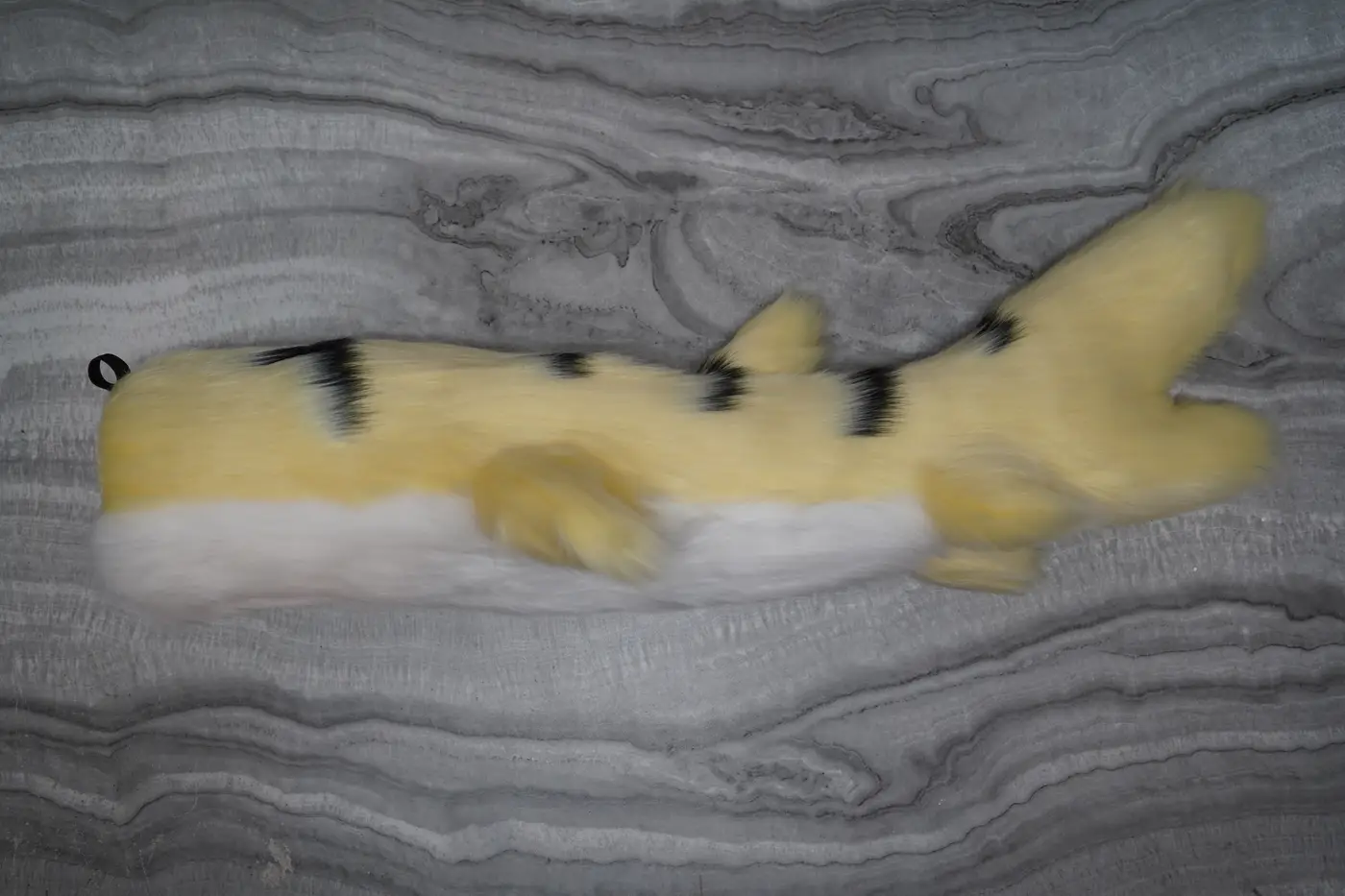 Cream Protogen tail with black stripes and a pale tip