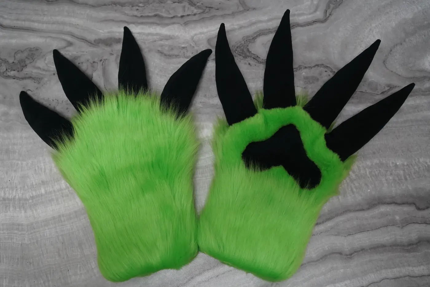 Lime green four finger claw hand paws with long black claws and black pads, made for the Protogen partial