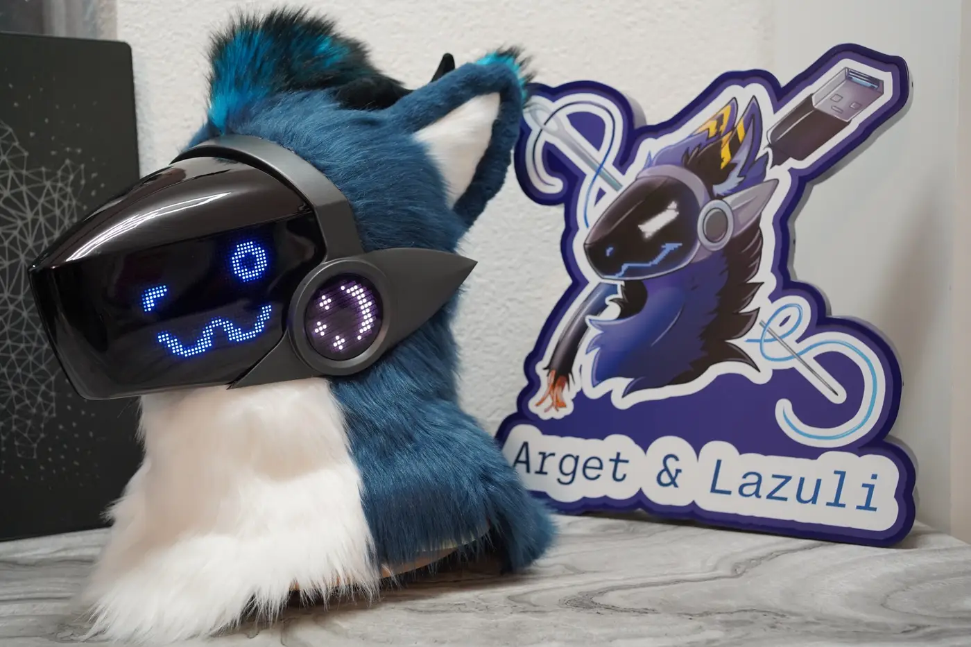 Teal and white Protogen head with wide blue eyes on the black LED visor