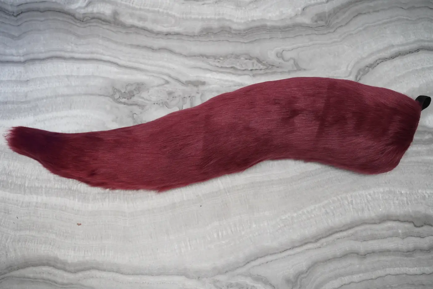 Long wavy burgundy Protogen tail with a tapered tip
