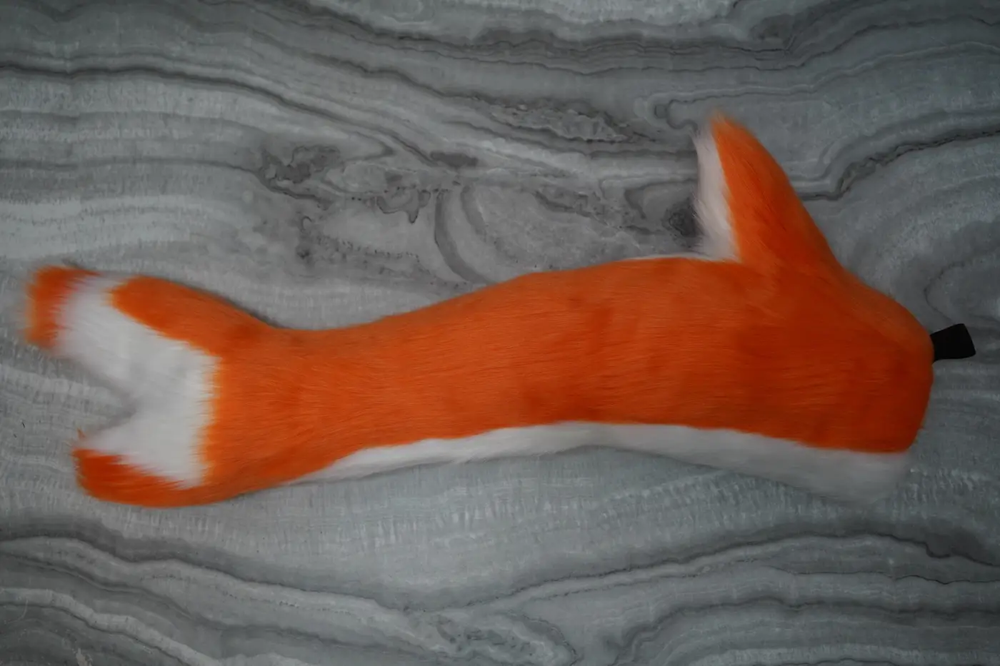 Orange Protogen tail with a white underside and a forked white tip