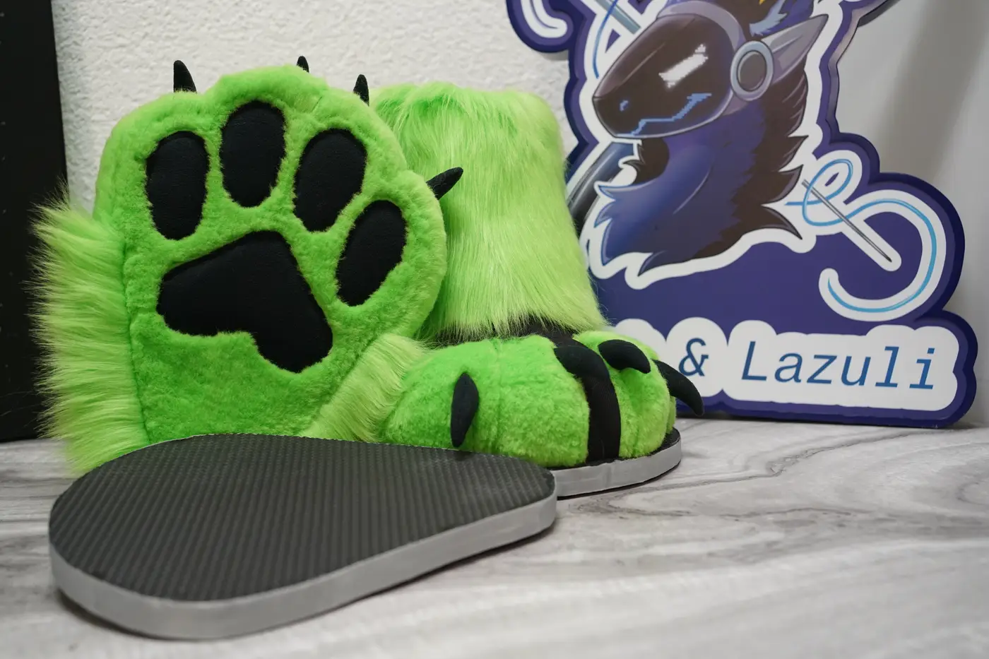 Lime green Protogen feet paws with black paw pads next to their gray outdoor sole sandals
