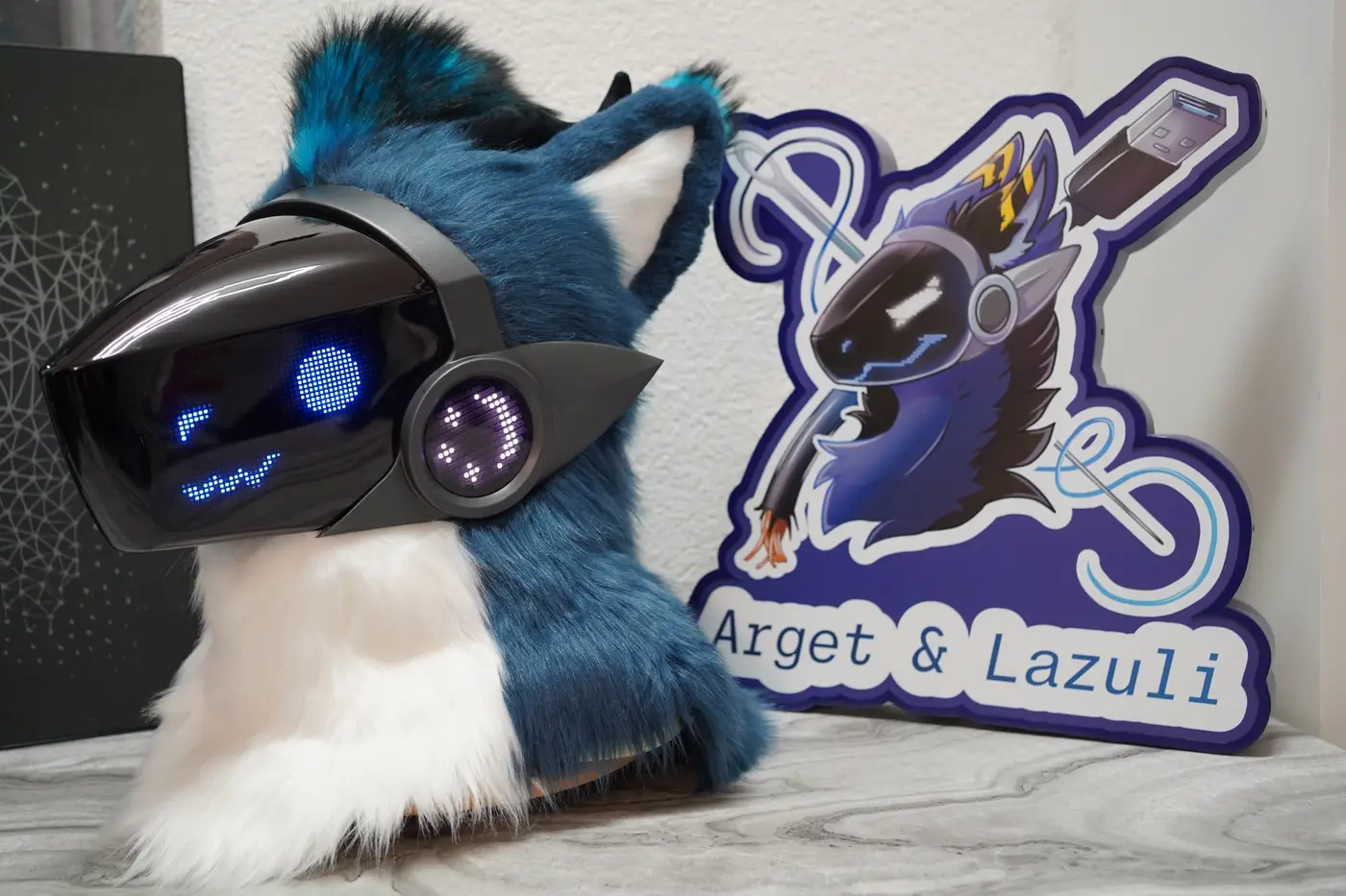 Teal Protogen head with narrow blue eyes and a zigzag mouth on the LED visor