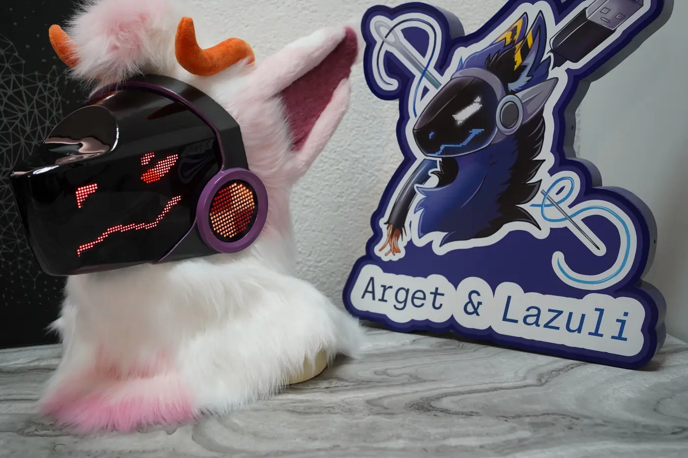 White and pink Protogen head with a purple rimmed cheek disc beside the LED visor