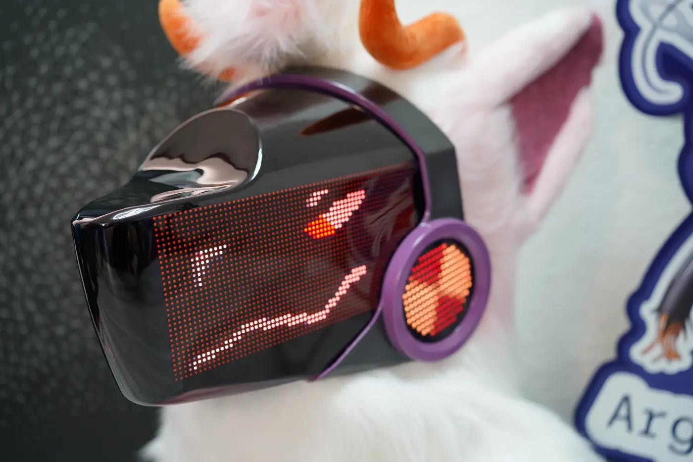 White and pink Protogen head with a red face filling the black LED visor