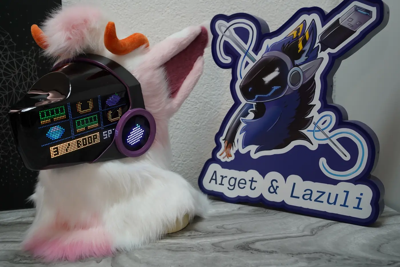 White and pink Protogen head with colour game icons and a status bar on the LED visor