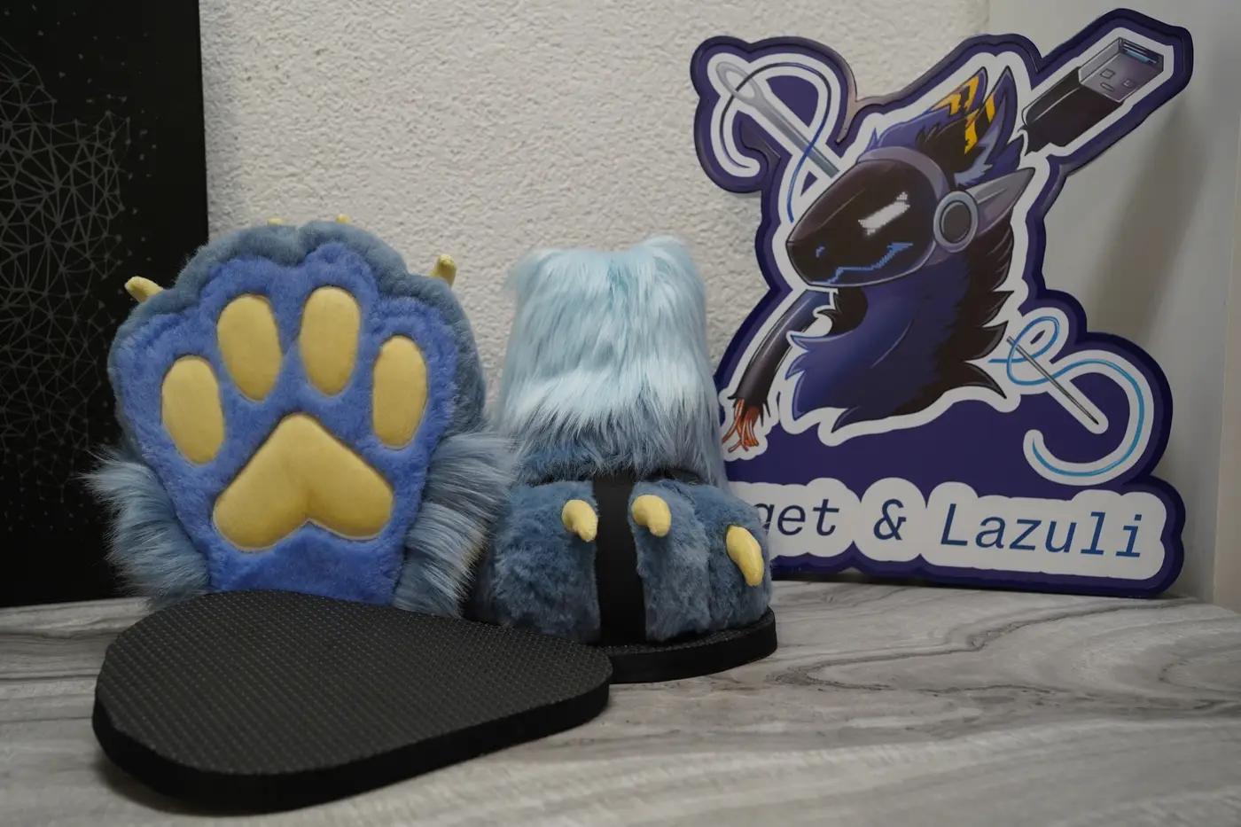Light blue Protogen feet paws with yellow paw pads and their black outdoor sole sandals
