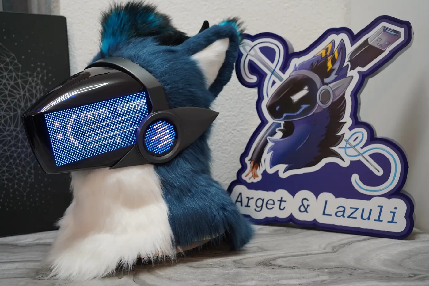 Teal Protogen head with colour game icons and a status bar on the LED visor