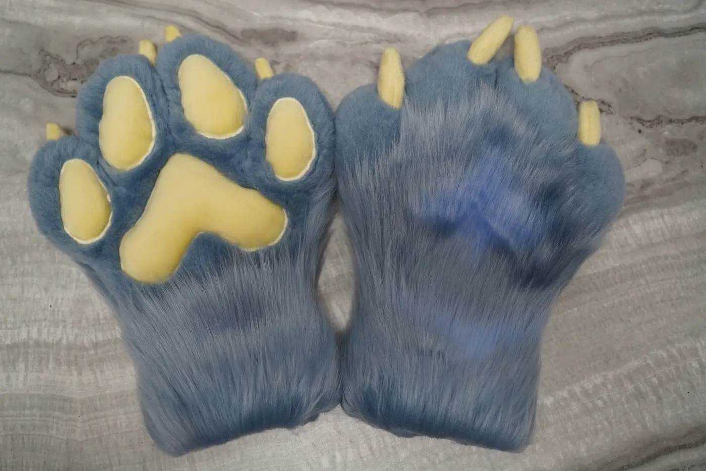 Light blue Protogen hand paws with yellow paw pads and yellow claws for the partial
