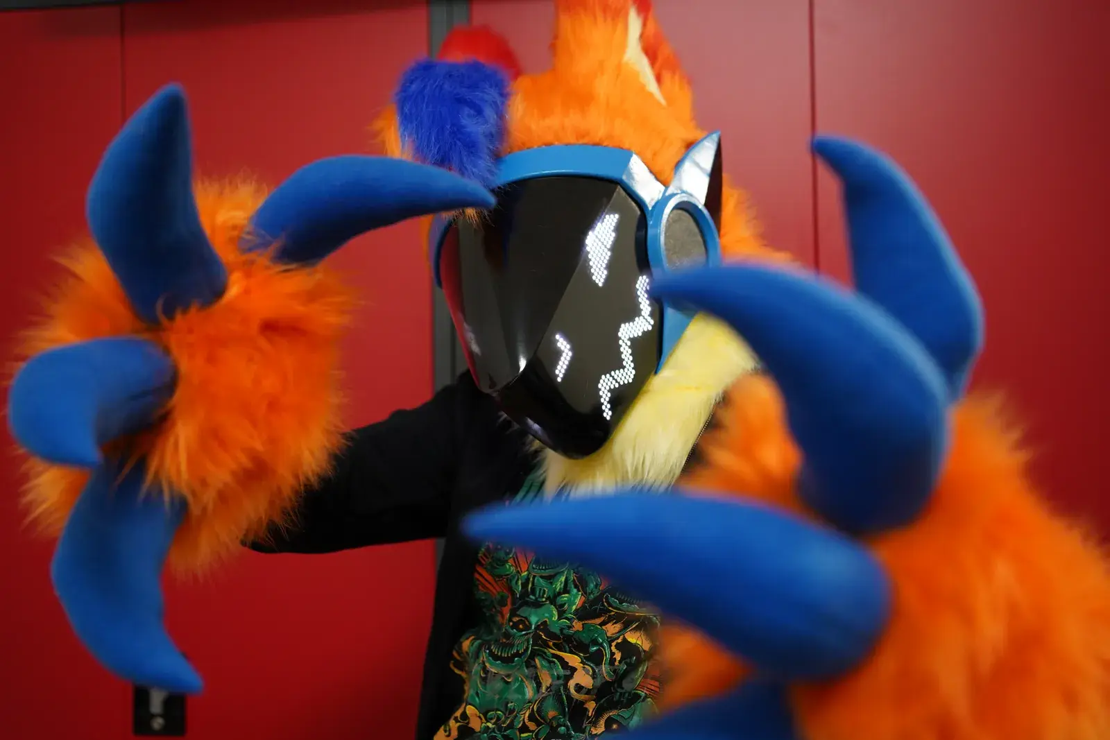 Orange and blue Protogen with silver horns and a black visor displaying white zigzag pixel eyes