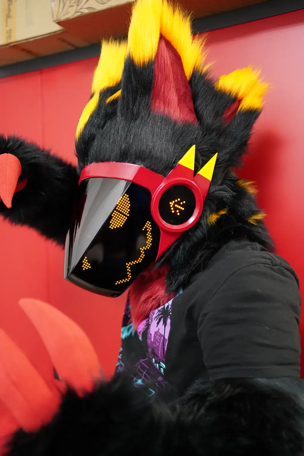 Black Protogen partial with a red visor frame, yellow horns and an amber LED pixel face