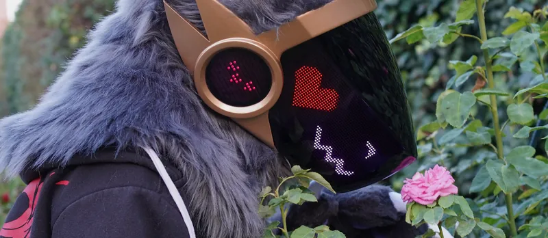 Grey Protogen full partial smelling a pink rose in the garden, a red heart and a purple wavy mouth on the LED visor, by Arget & Lazuli